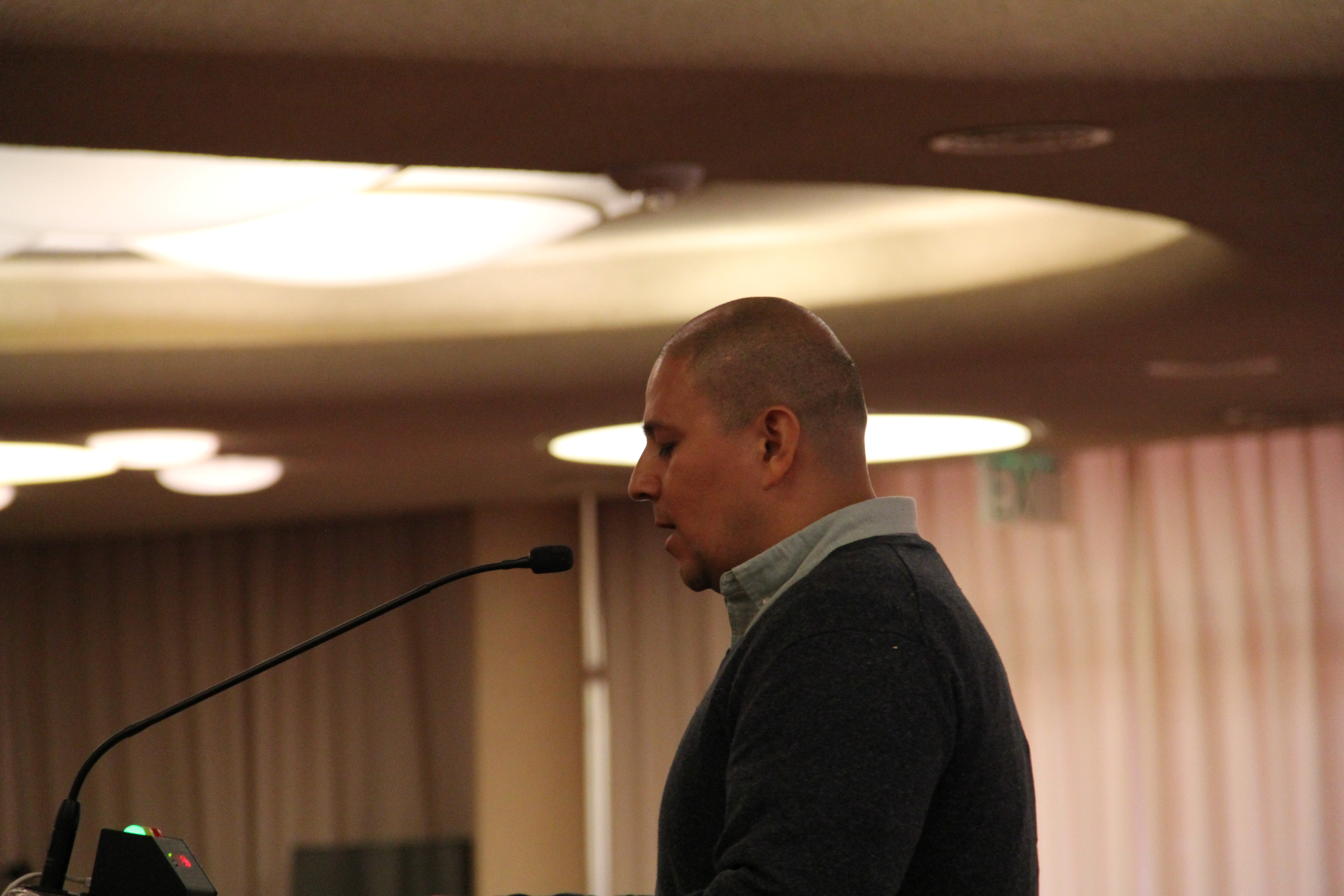 Jon Deras speaking at podium